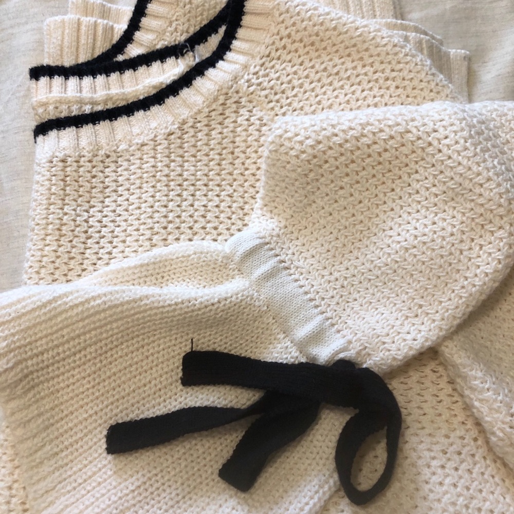 White sweater with black bow detail